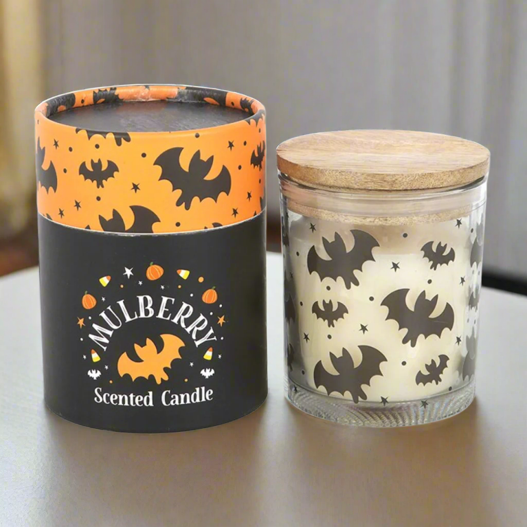 Halloween-themed scented candle with decorative packaging on a white background