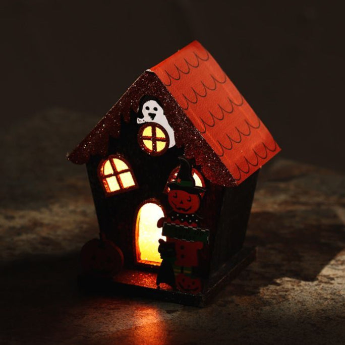 Halloween-themed decorative house with glowing windows on a dark background