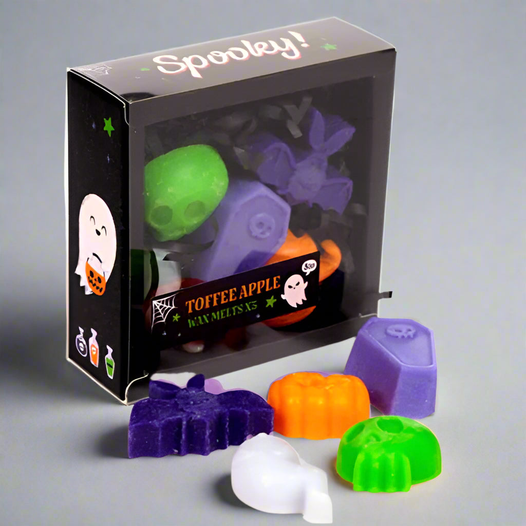 Halloween-themed wax melts in front of their packaging with 'Spooky!' text.