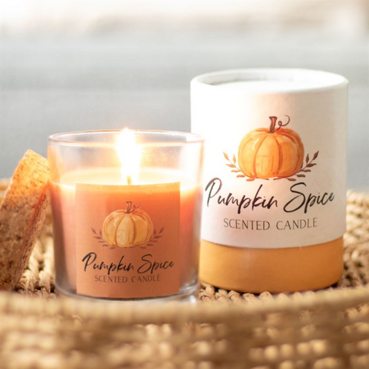 Pumpkin spice scented candles with pumpking graphics on a neutral background
